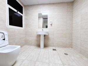 a bathroom with a sink and a toilet at Rose Building in Dubai