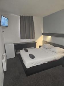 a bedroom with a bed and a television in it at Class-Hôtel in Poitiers