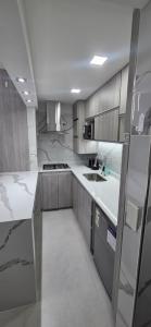a kitchen with white counter tops and gray cabinets at Roca Madryn in Puerto Madryn