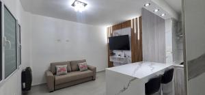 a living room with a table and a couch at Roca Madryn in Puerto Madryn
