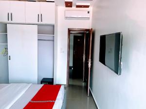 a bedroom with a bed and a tv on a wall at Comfort Deluxe Apart in Kigali
