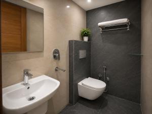a bathroom with a white sink and a toilet at Collection O Guru Nanak Dev University Amritsar Formerly Hotel Tashi in Amritsar