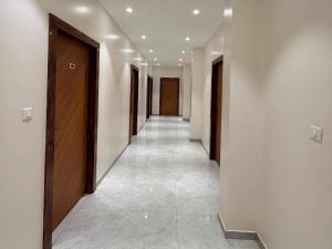 a hallway with a row of elevators in a building at Collection O Sunset Point Pangari Formerly Riveria in Mahabaleshwar