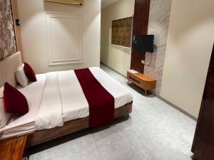 a bedroom with a bed and a tv in it at Collection O Sunset Point Pangari Formerly Riveria in Mahabaleshwar +20 photos