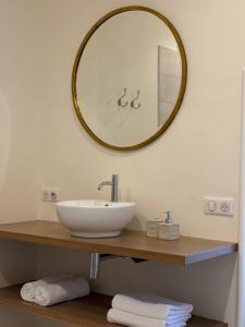 a bathroom with a sink and a mirror on the wall at Château Saint Georges in Mauléon +4 photos