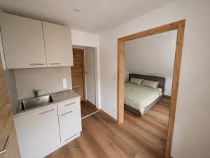 a kitchen with a sink and a bed in a room at Haus Anni in Ebermannstadt