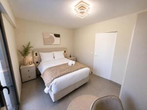 a bedroom with a large white bed in a room at The Eight in Luxembourg +24 photos