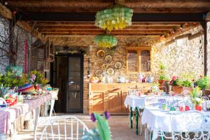 a room with tables and chairs and a kitchen at Can Portell by 123ole, B&B - Casa Rural in Sant Andreu del Terri