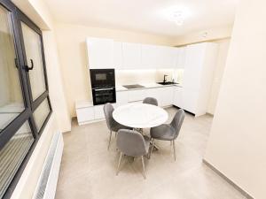a kitchen with a table and chairs in a room at The Eight in Luxembourg