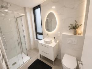 a bathroom with a toilet sink and a shower at The Eight in Luxembourg