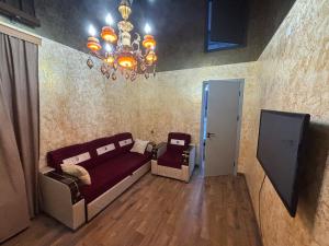 a living room with a couch and a chandelier at Apartment in Jvari in Jvari