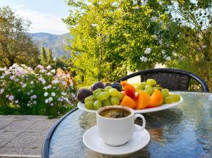 a plate of fruit and a cup of coffee on a table at Guest House in Sanahin in Sanain +2 photos