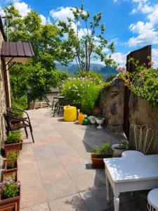 a patio with tables and chairs and flowers at Guest House in Sanahin in Sanain