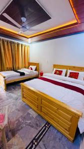 a bedroom with two beds in a room at Kaka G Hotel Utror Valley in Utrot
