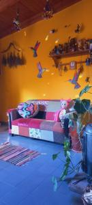 a couch with a teddy bear sitting on it in a room at Casa Munay in Maimará