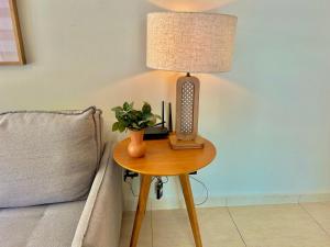 a lamp sitting on a table next to a couch at Edifício Barão Filippi in Águas de Lindoia +25 photos