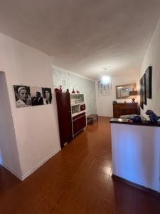 a living room with a kitchen with a refrigerator at La terrazza del Conte in Siena