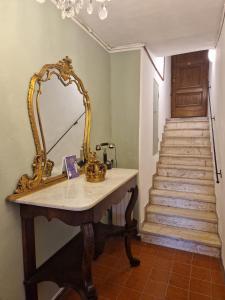 a dressing table with a mirror and a staircase at La terrazza del Conte in Siena