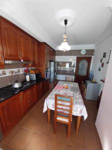 a kitchen with a table with a white table cloth at Yamina's Holiday in Raoued