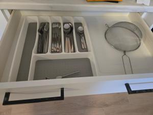 a drawer with utensils in a kitchen at Private Guest Suite Sleeps 4 in Riverview