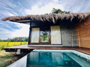 a small hut with a swimming pool in front of it at Ranakeliya Lodge - Yala in Yala