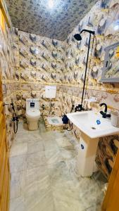 a bathroom with a sink and a toilet at Kaka G Hotel Utror Valley in Utrot