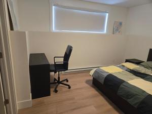 a bedroom with a desk and a bed and a chair at Private Guest Suite Sleeps 4 in Riverview