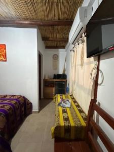 a room with two beds and a television in it at Luna Victoria - apart in Purmamarca