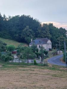 a house sitting on the side of a road at Location Fermette in Goulles