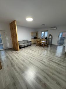 a living room with a bed and a table in it at Luca House in Remetea Mare +2 photos