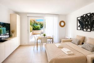 a bedroom with a large bed and a dining room at Cap et Soleil Peaceful Private Garden, 2 Terraces, Pool, Garage, 5 Min Walk to Beach in Antibes