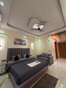 a bedroom with a bed and a ceiling fan at Aureva stays Omaxe Hazratganj in Nalmatha