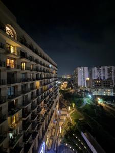 a view of a building at night at Aureva stays Omaxe Hazratganj in Nalmatha