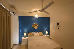 a bedroom with a bed with a blue wall at calming valley in Luxor