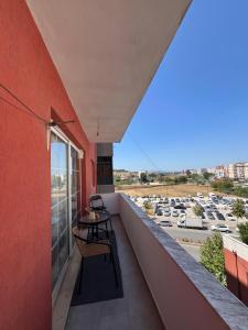 a balcony with a table and a view of a parking lot at Casa Trio in Tirana