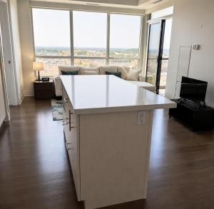 an office with a white island in the middle of a living room at SimplyBnB in Vaughan