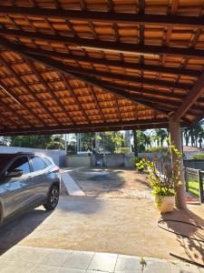 a car parked under a wooden pergola at orquídea in Paulínia