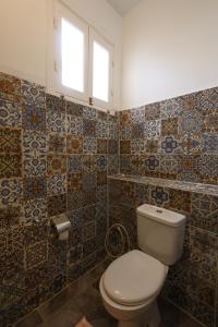 a bathroom with a toilet and a window and tiles at calming valley in Luxor +65 photos