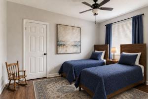 a bedroom with two beds and a ceiling fan at Alpine Haven Getaway in Vail