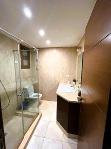 a bathroom with a toilet and a sink and a shower at Sabina 2BD with pool and lagoon view in Hurghada +24 photos