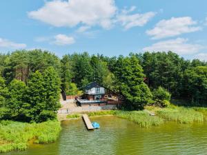 an aerial view of a house in the middle of a river at Szept Wody Kaszuby in Lubiana