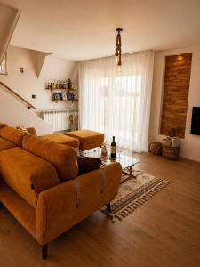 a living room with a couch and a table at Topli kutak Golija in Novi Pazar