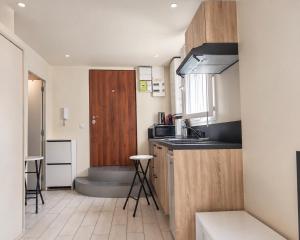 a kitchen with a sink and a wooden door at Coconing sur Ivry-sur-seine Proche Paris in Ivry-sur-Seine