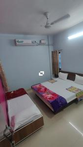 a bedroom with two beds and a ceiling at Hotel adiraj palace exclusive in Ahmadnagar