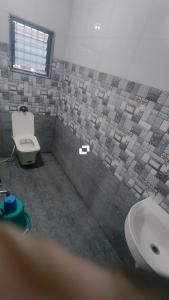 a bathroom with a toilet and a sink at Hotel adiraj palace exclusive in Ahmadnagar