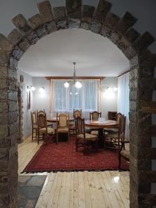 a dining room with a table and chairs at Стаи за гости "Архангел Михаил" in Kostenets