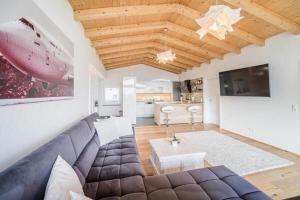 a living room with a couch and a table at Tyrolhaus in Grinzens