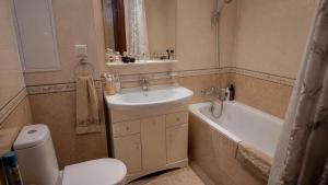 a bathroom with a sink and a toilet and a bath tub at Dream Stay in Schwanewede
