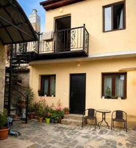 a building with a table and chairs in front of it at MaVi House in Kutaisi