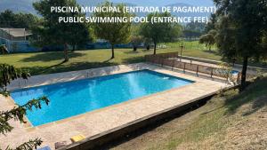 a swimming pool in a grassy area next to a park at Apartament reformat al Berguedà 6p in Sant Jordi de Cercs